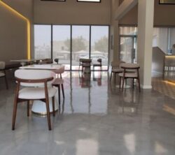 Modern café interior featuring polished concrete floors, stylish wooden furniture, and large windows allowing natural light. The space is designed for comfort with a minimalist aesthetic, showcasing a welcoming atmosphere for patrons.